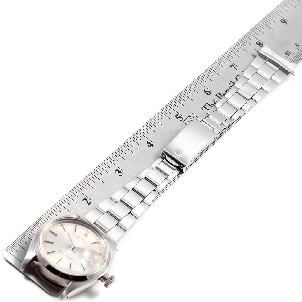 The image shows the Rolex Vintage Collection 1500 Men's Stainless Steel Silver Dial 1500 Men's Stainless Steel Silver Dial watch laid flat with a ruler to measure the length of the stainless steel bracelet.
