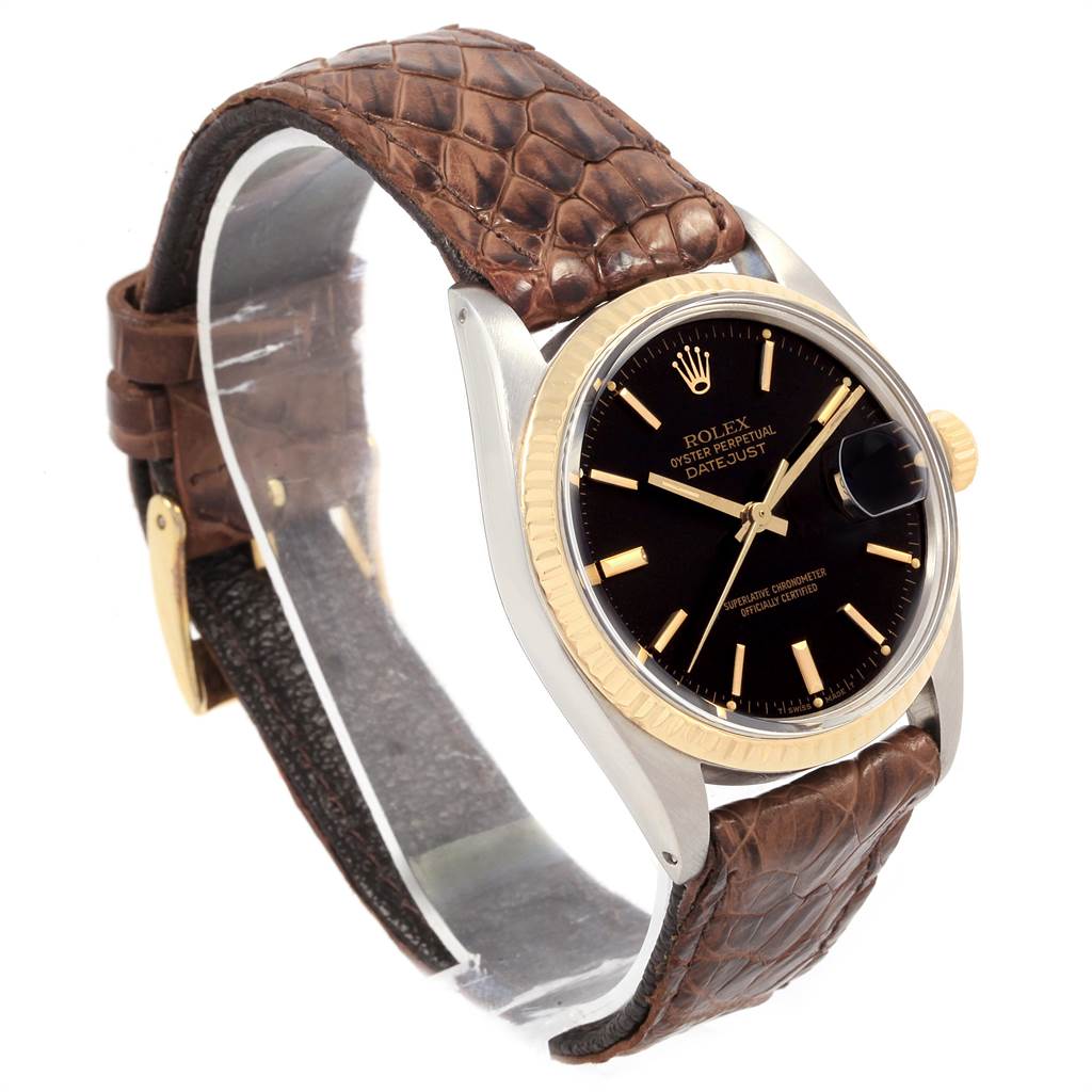 The image shows a side angle view of the Vintage Collection Rolex Datejust, highlighting its black dial and brown leather strap.