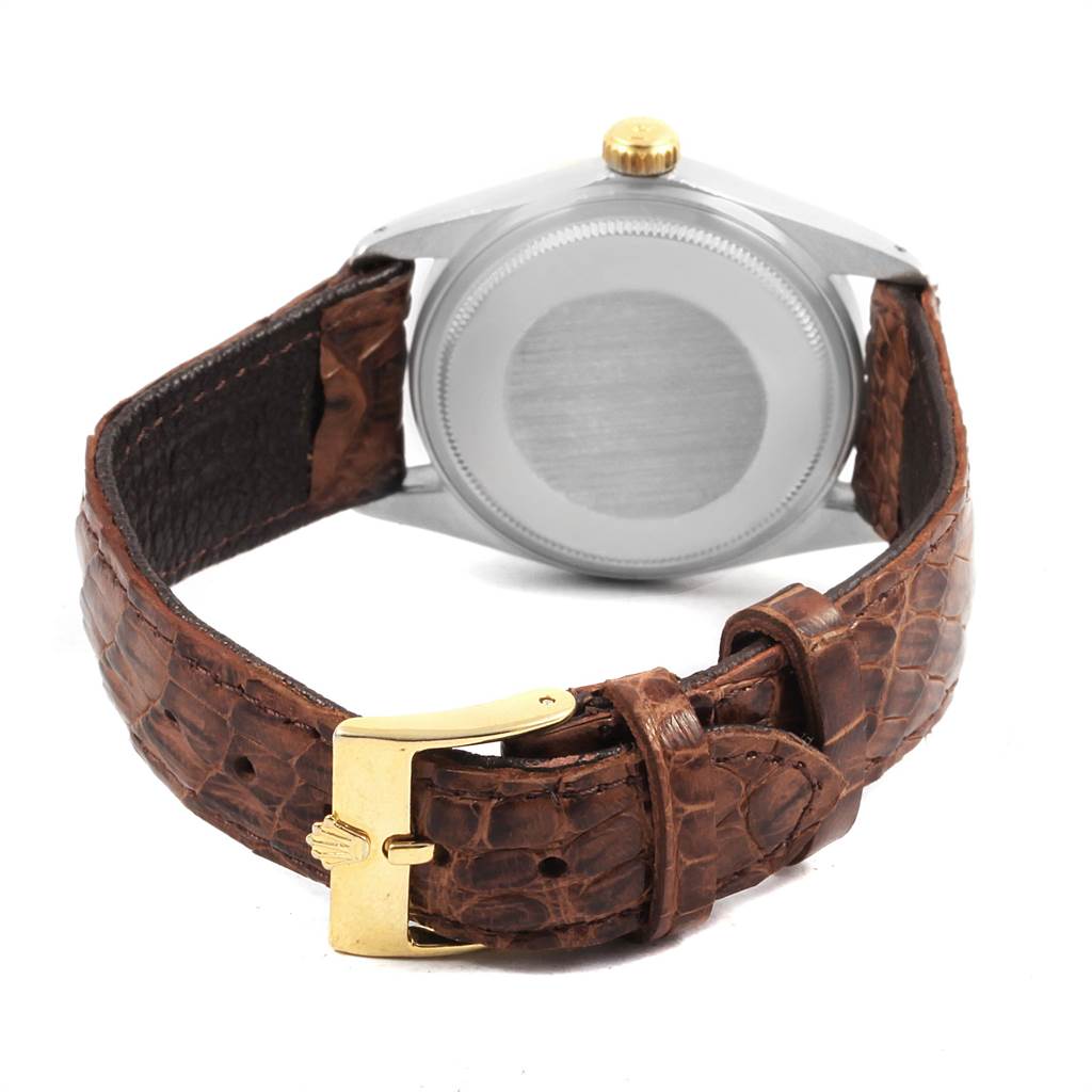 The image shows the back of a Rolex Vintage Collection 16013 Men's Stainless Steel Black Dial 16013 Men's Stainless Steel Black Dial watch, highlighting its leather strap and gold buckle.