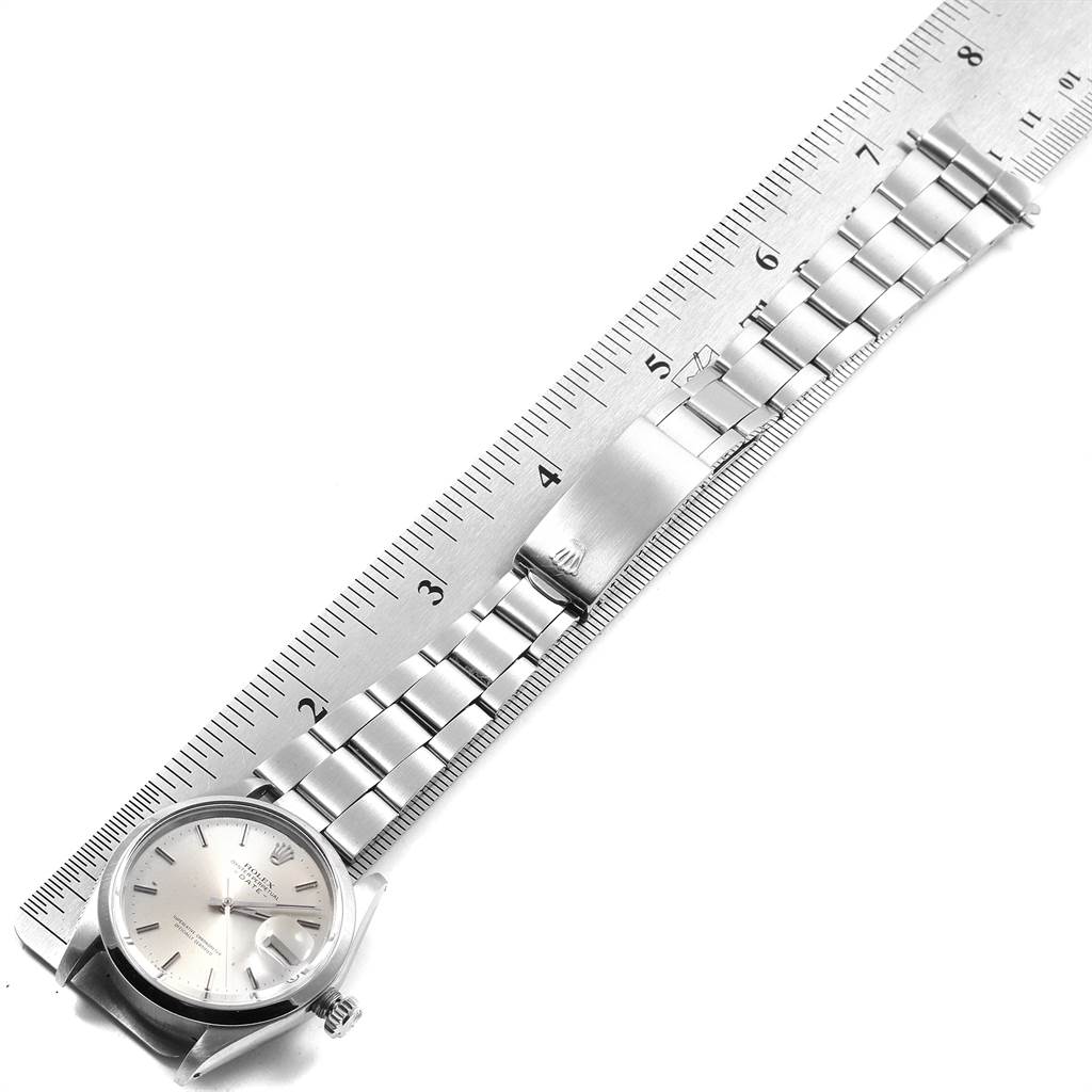 The image shows a Rolex Vintage Collection 1500 Men's Stainless Steel Silver Dial 1500 Men's Stainless Steel Silver Dial watch laid flat with a ruler, displaying its dial, bracelet, and clasp.