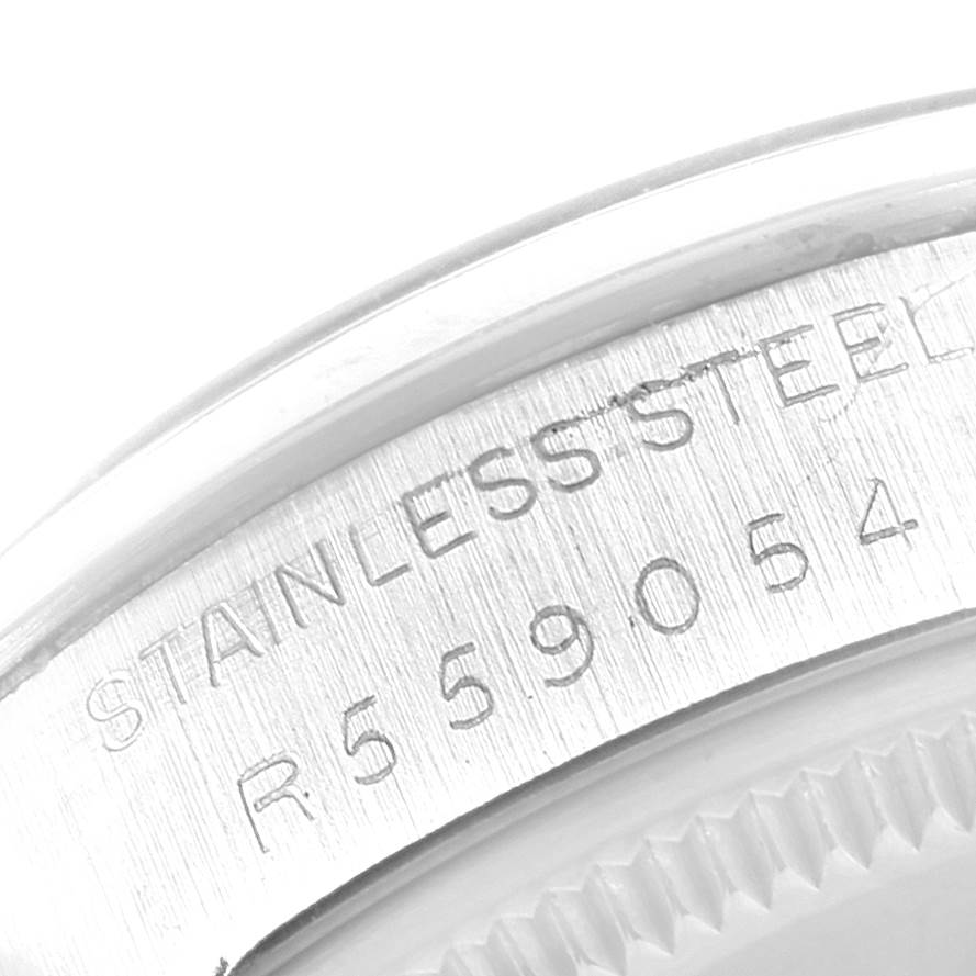 The image shows a close-up of the case back and edge of the bezel with the stainless steel inscription and model number of the Rolex Vintage Collection 1002 Men's Stainless Steel Silver Dial 1002 Men's Stainless Steel Silver Dial watch.