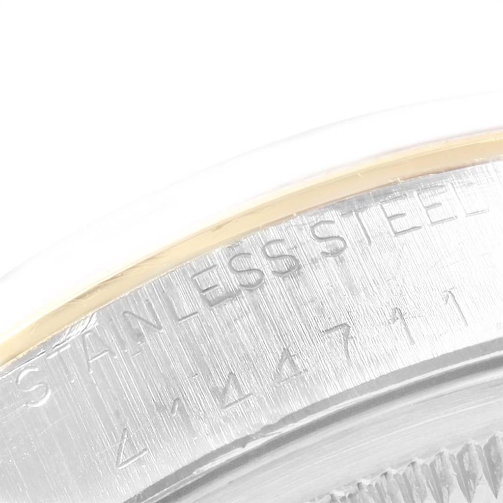 This image shows a close-up of the stainless steel case back of the Vintage Collection watch by Rolex, highlighting the serial number.