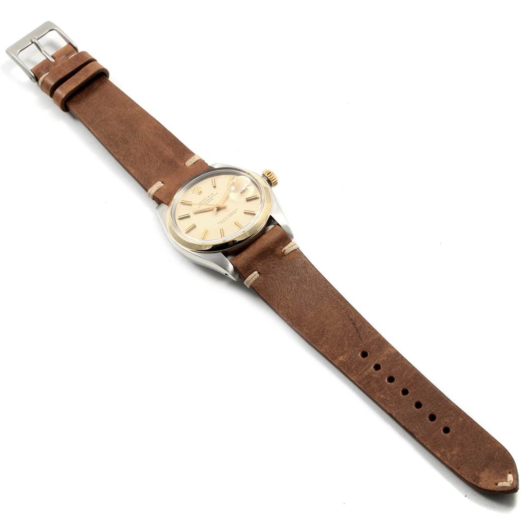 This image shows a Rolex Vintage Collection 1500 Men's Stainless Steel Silver Dial 1500 Men's Stainless Steel Silver Dial watch at an angled top view, highlighting its brown leather strap and beige dial.