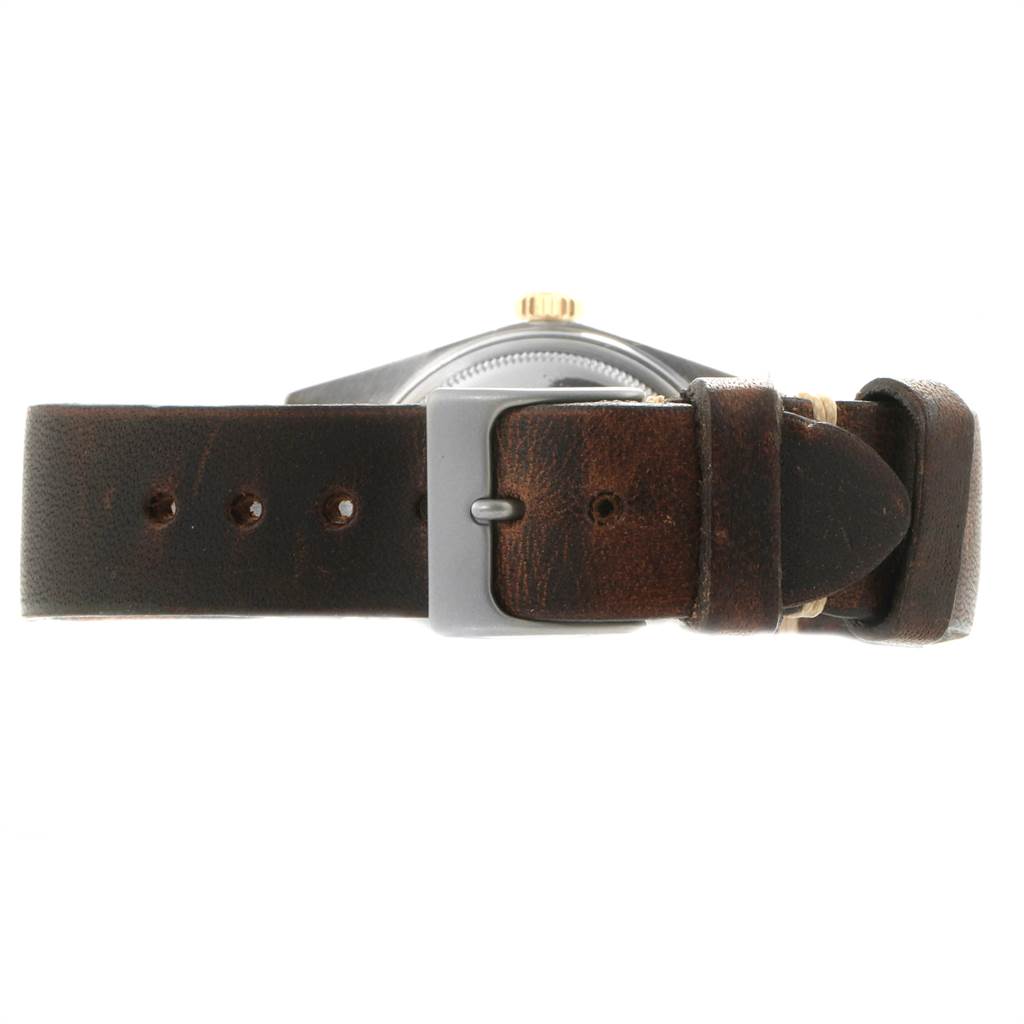 This image shows a side angle of a Rolex Vintage Collection 16013 Men's Stainless Steel Champagne Dial 16013 Men's Stainless Steel Champagne Dial watch, featuring a brown leather strap and a buckle.