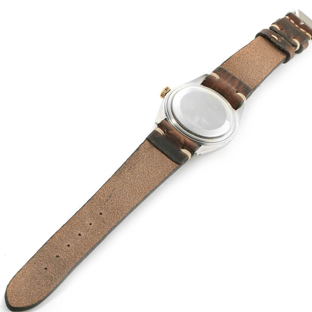 The image shows the back case and band of a Vintage Collection Rolex watch from a slightly angled view.