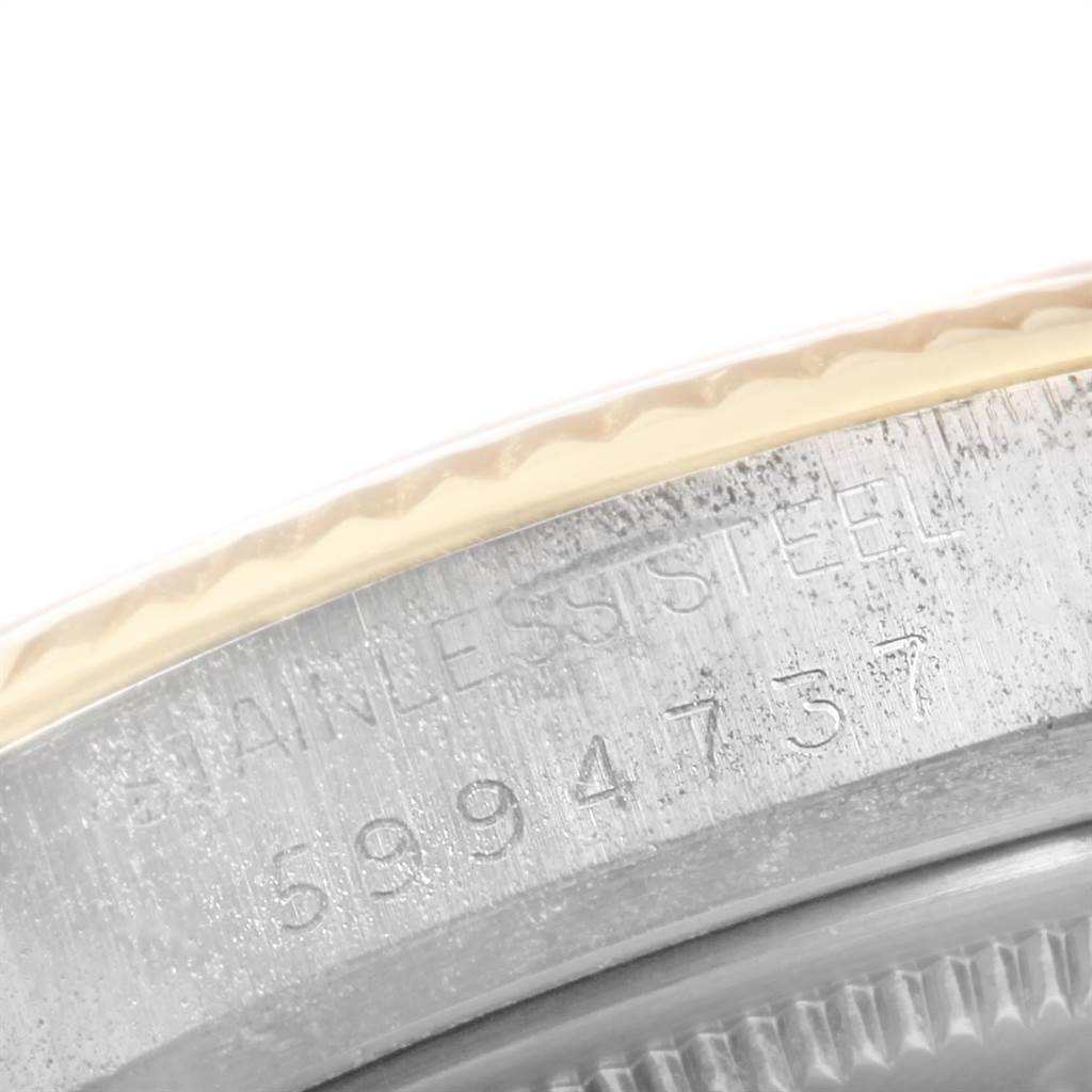 The image shows a close-up view of the stainless steel back casing of a Vintage Collection model by Rolex, with visible serial numbers.