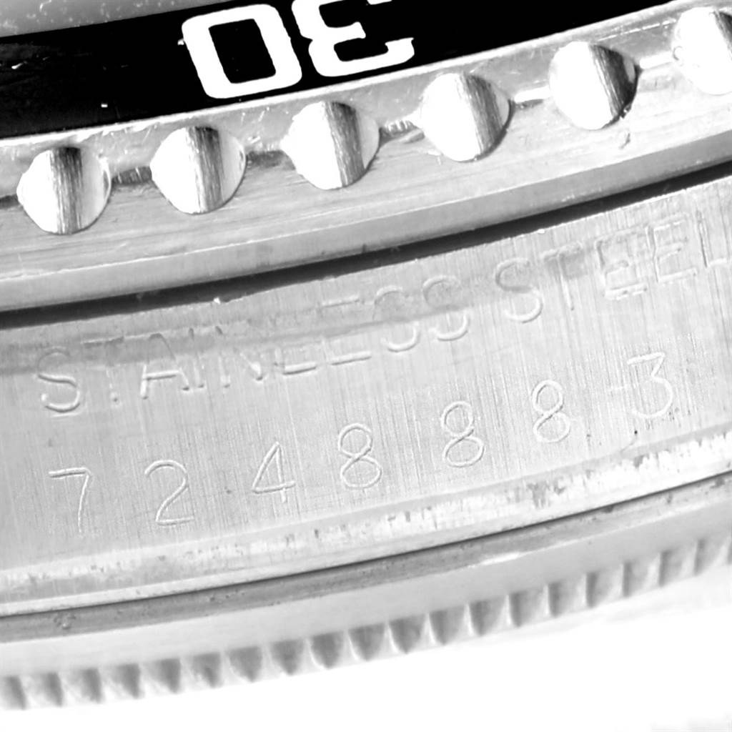 This close-up shows the bezel and serial number engraving on a Rolex Vintage Collection 16800 Men's Stainless Steel Black Dial 16800 Men's Stainless Steel Black Dial model watch, highlighting its "STAINLESS STEEL" text and numerals.
