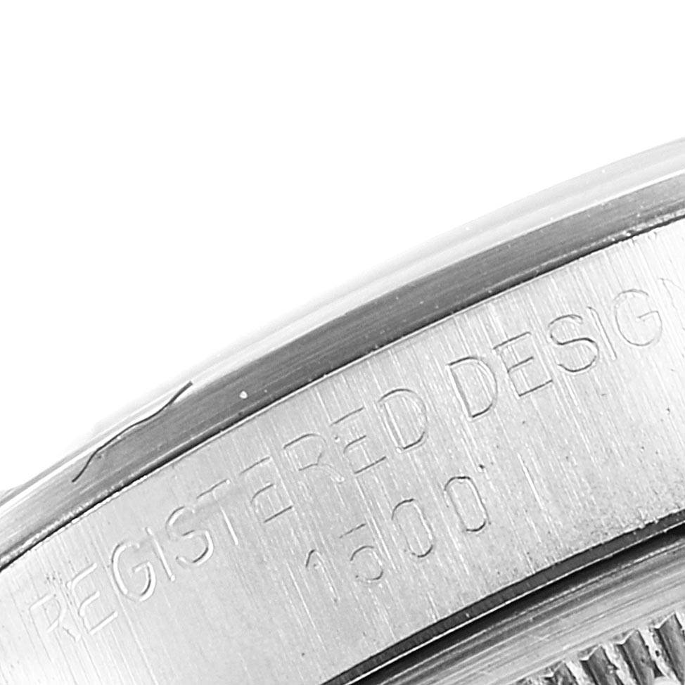 This image shows a close-up of the side of a Rolex Vintage Collection 1500 Men's Stainless Steel Silver Dial 1500 Men's Stainless Steel Silver Dial model, highlighting its engraved design details.