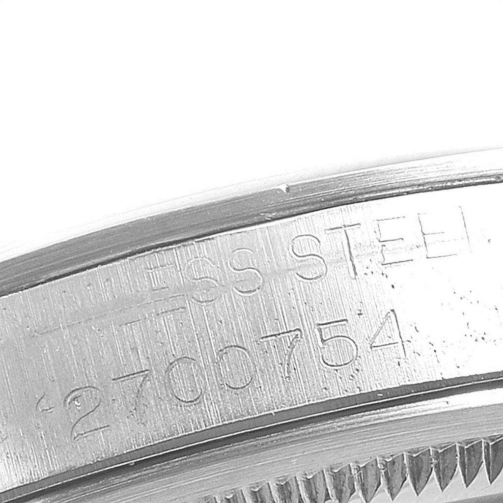 This is a close-up image showing the serial number and material ("STAINLESS STEEL") engraving on the side of a Rolex Vintage Collection 1500 Men's Stainless Steel Silver Dial 1500 Men's Stainless Steel Silver Dial watch.