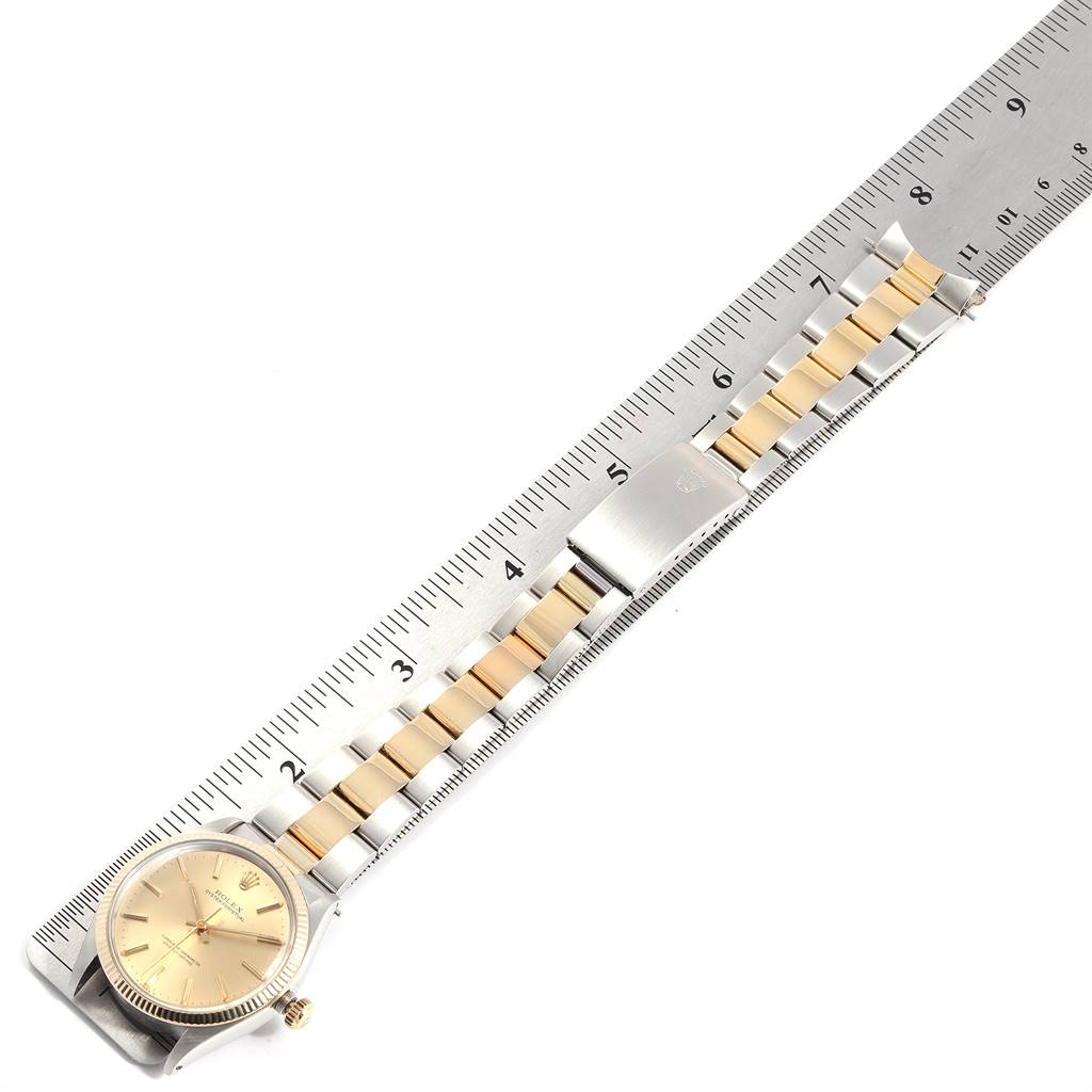 The image displays a Rolex Vintage Collection 1005 Men's Steel and Gold (two tone) Champagne Dial 1005 Men's Steel and Gold (two tone) Champagne Dial watch laid flat with a ruler showing its length and bracelet segments.