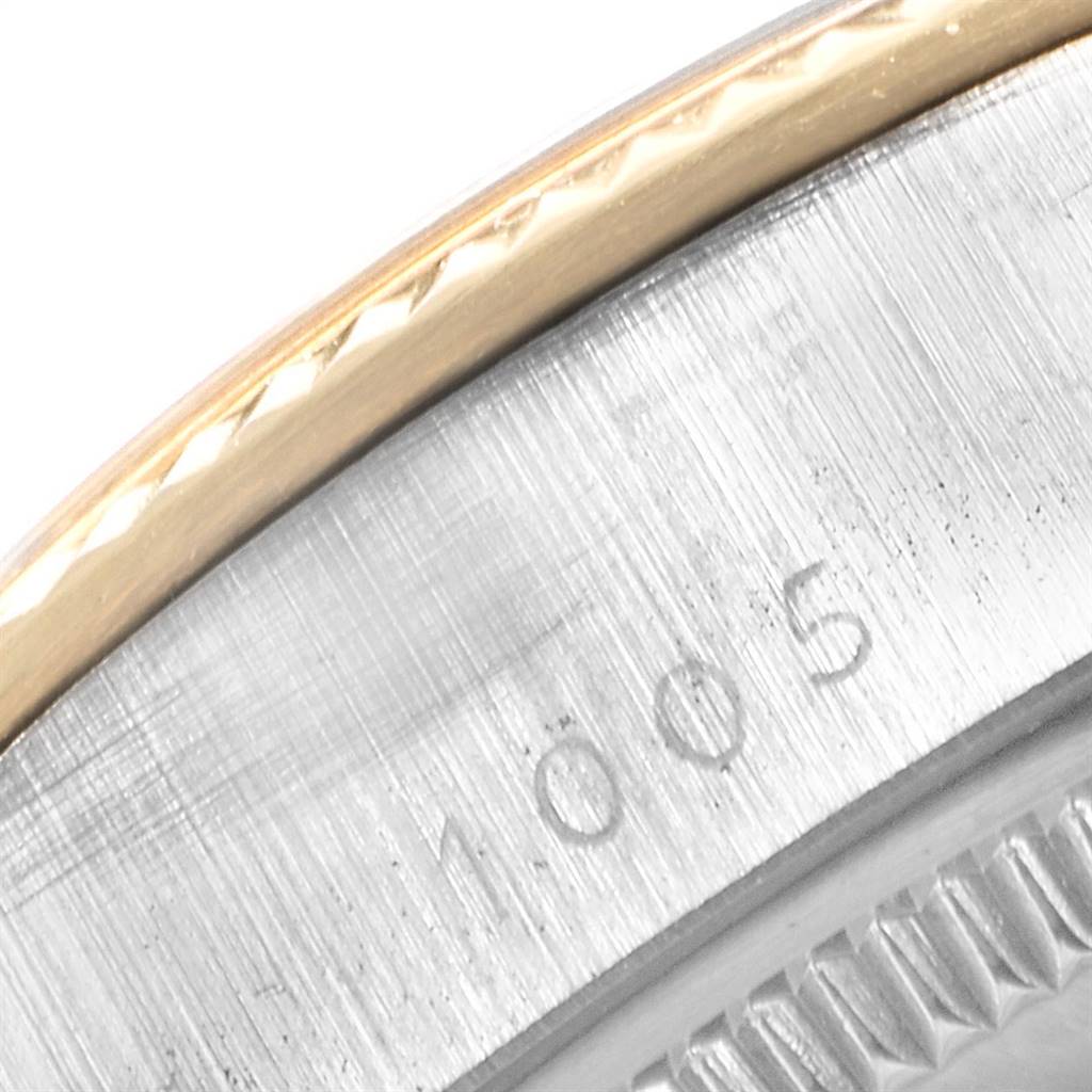 This image shows a close-up of the edge and bezel of a Rolex Vintage Collection 1005 Men's Steel and Gold (two tone) Champagne Dial 1005 Men's Steel and Gold (two tone) Champagne Dial watch, highlighting the serial number.