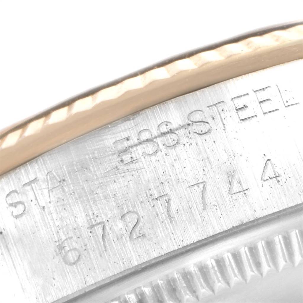 This image shows a close-up view of the serial number and "STAINLESS STEEL" engraving on the bezel of the Rolex Vintage Collection 1005 Men's Steel and Gold (two tone) Champagne Dial 1005 Men's Steel and Gold (two tone) Champagne Dial model.