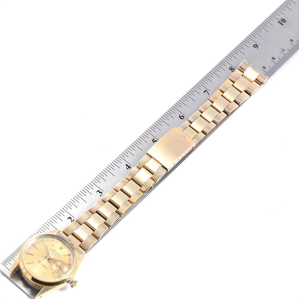 The image shows a top view of a Rolex Vintage Collection 15505 Men's Champagne Dial 15505 Men's Champagne Dial watch with a focus on its golden strap and metallic ruler for scale.