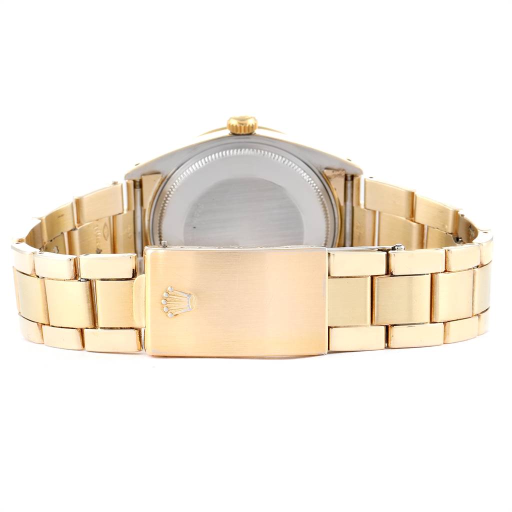 The image shows the back view of a Rolex Vintage Collection 15505 Men's Champagne Dial 15505 Men's Champagne Dial watch, highlighting its gold bracelet and clasp.