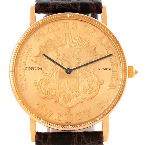 The image shows a frontal view of the Corum Coin Watch Men's Yellow Gold Black Dial Men's Yellow Gold Black Dial model, highlighting its coin-like dial, hands, and leather strap.