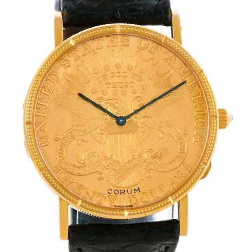 The image shows a front view of the Corum Coin Watch Men's Yellow Gold Black Dial Men's Yellow Gold Black Dial model, highlighting its detailed coin-like watch face and black leather strap.