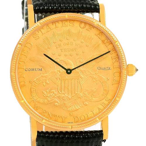 The image shows a front view of the Corum Coin Watch Men's Yellow Gold Black Dial Men's Yellow Gold Black Dial model, highlighting its golden dial and black leather strap.