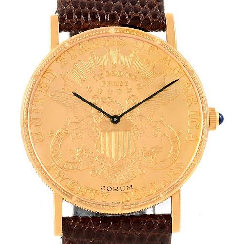 The image shows a front view of the Corum Coin Watch Men's Yellow Gold Black Dial Men's Yellow Gold Black Dial, displaying the engraved dial and part of the brown strap.