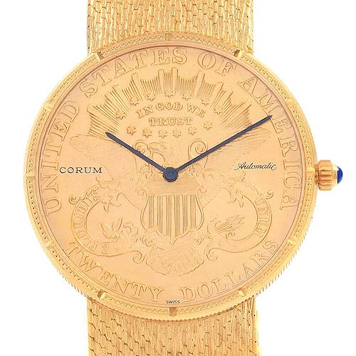 The Corum Coin Watch Men's Yellow Gold Black Dial Men's Yellow Gold Black Dial model is shown from a front angle, highlighting its detailed gold coin face, hands, and textured strap.