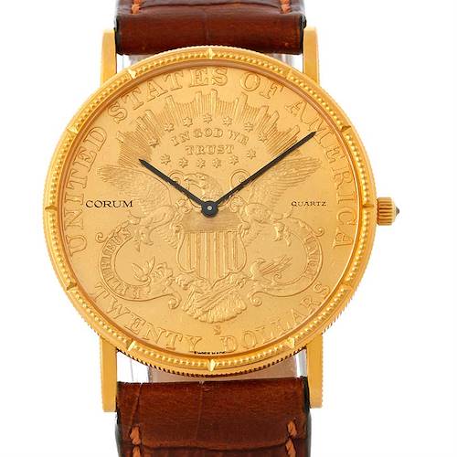 The image shows a frontal view of a Corum Coin Watch Men's Yellow Gold Black Dial Men's Yellow Gold Black Dial model, displaying its dial, hands, golden case, and brown leather strap.
