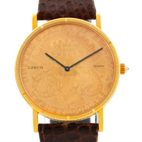 The image shows a front view of the Corum Coin Watch Men's Yellow Gold Black Dial Men's Yellow Gold Black Dial model, highlighting the dial, bezel, strap, and crown.