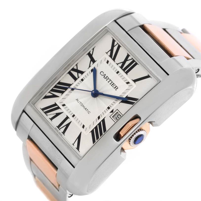 The image shows a close-up angle of the Cartier Tank Anglaise W5310006 Men's Steel and Gold (two tone) Silver Dial W5310006 Men's Steel and Gold (two tone) Silver Dial watch, featuring its face, blue hands, and crown with a blue cabochon.