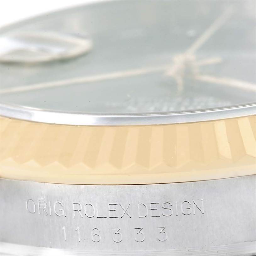 Close-up of the side of a Rolex Datejust 41 116333 Men's Steel and Gold (two tone) Grey Dial 116333 Men's Steel and Gold (two tone) Grey Dial watch, showing the fluted bezel and "ORIG. ROLEX DESIGN" engraving.