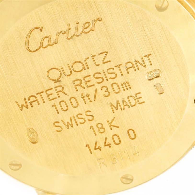 Close-up of the back case of a Cartier Diabolo 1400 Women's Yellow Gold Silver Dial 1400 Women's Yellow Gold Silver Dial watch showing engravings and specifications.