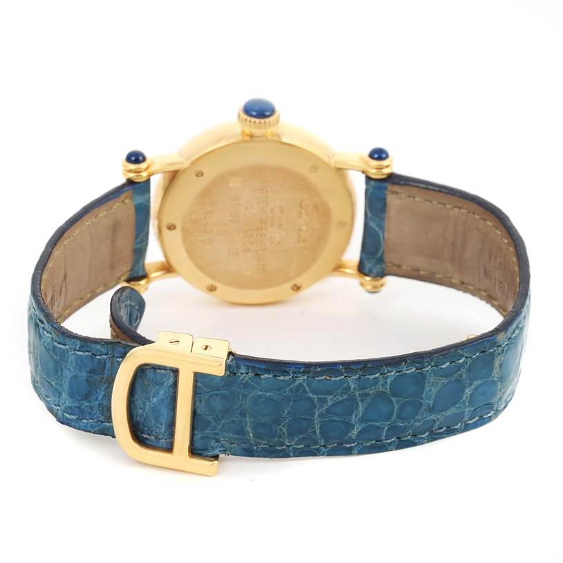 The Cartier Diabolo 1400 Women's Yellow Gold Silver Dial 1400 Women's Yellow Gold Silver Dial watch is shown from the rear, featuring its caseback, blue strap, and gold clasp.