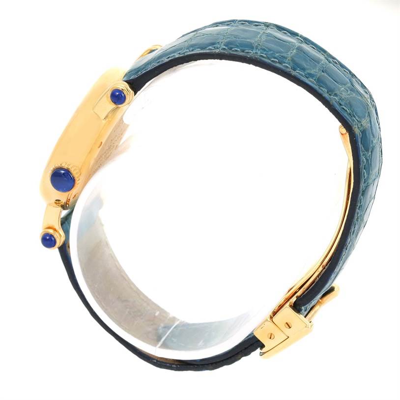 The image shows a side view of the Cartier Diabolo 1400 Women's Yellow Gold Silver Dial 1400 Women's Yellow Gold Silver Dial watch, highlighting its blue strap and gold case with blue accents.