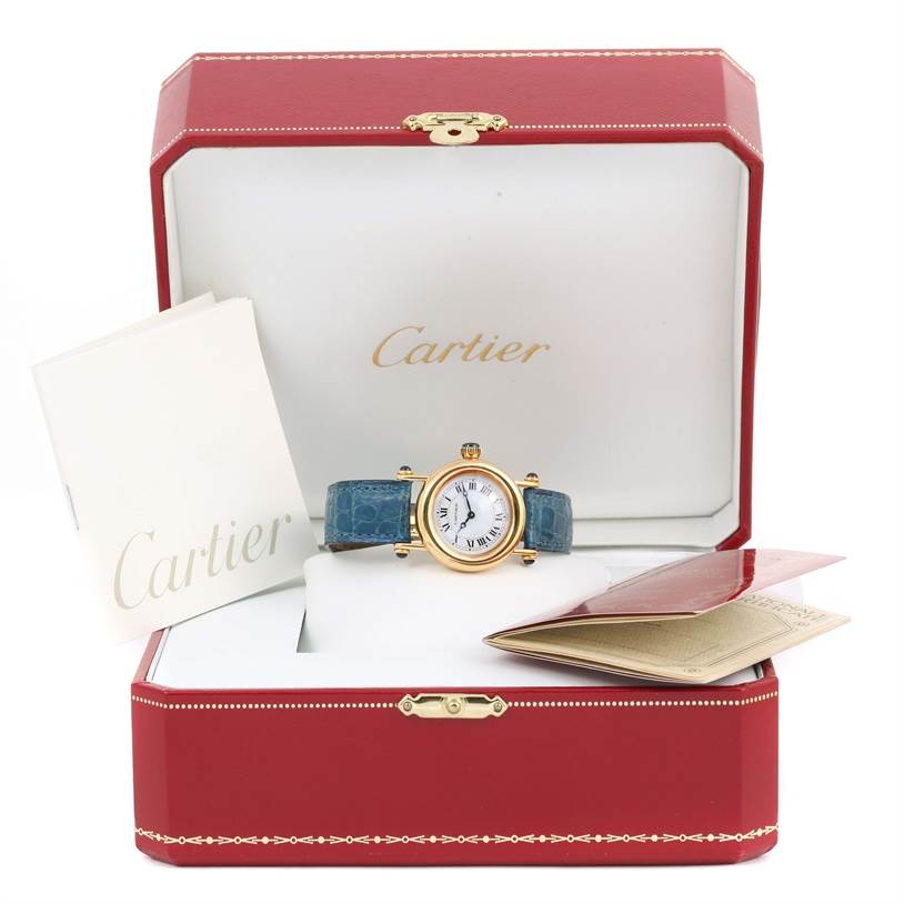 The image shows a Cartier Diabolo 1400 Women's Yellow Gold Silver Dial 1400 Women's Yellow Gold Silver Dial model watch with a blue strap in an open red Cartier box, along with booklets.