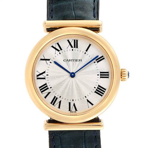 This image shows a close-up of a Cartier Vendome W1514457 Men's Yellow Gold Silver Dial W1514457 Men's Yellow Gold Silver Dial model watch face, featuring Roman numerals and blue hands, attached to a leather strap.