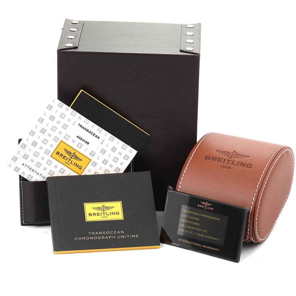 The image shows the packaging, manual, international warranty, and travel case for a Breitling Transocean AB0510 Men's Stainless Steel Silver Dial AB0510 Men's Stainless Steel Silver Dial watch.