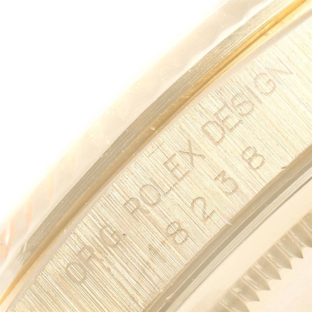 The image shows a close-up of the side engraving and part of the bezel of a Rolex President 18238 Men's Yellow Gold Champagne Dial 18238 Men's Yellow Gold Champagne Dial model watch.
