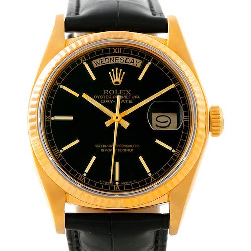 The image shows a front view of a Rolex President 18038 Men's Yellow Gold Black Dial 18038 Men's Yellow Gold Black Dial model watch displaying the day, date, and time.