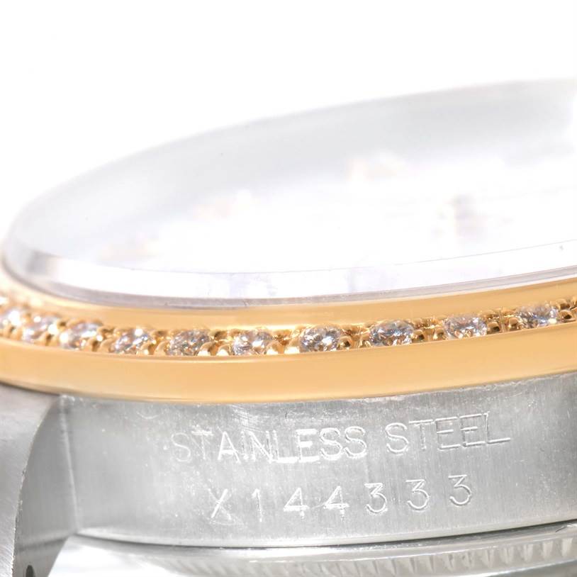 The image shows a close-up side view of the Rolex Datejust 16233 Men's Steel and Gold (two tone) Mother of Pearl Dial 16233 Men's Steel and Gold (two tone) Mother of Pearl Dial watch, highlighting its bezel with diamonds and part of the case.