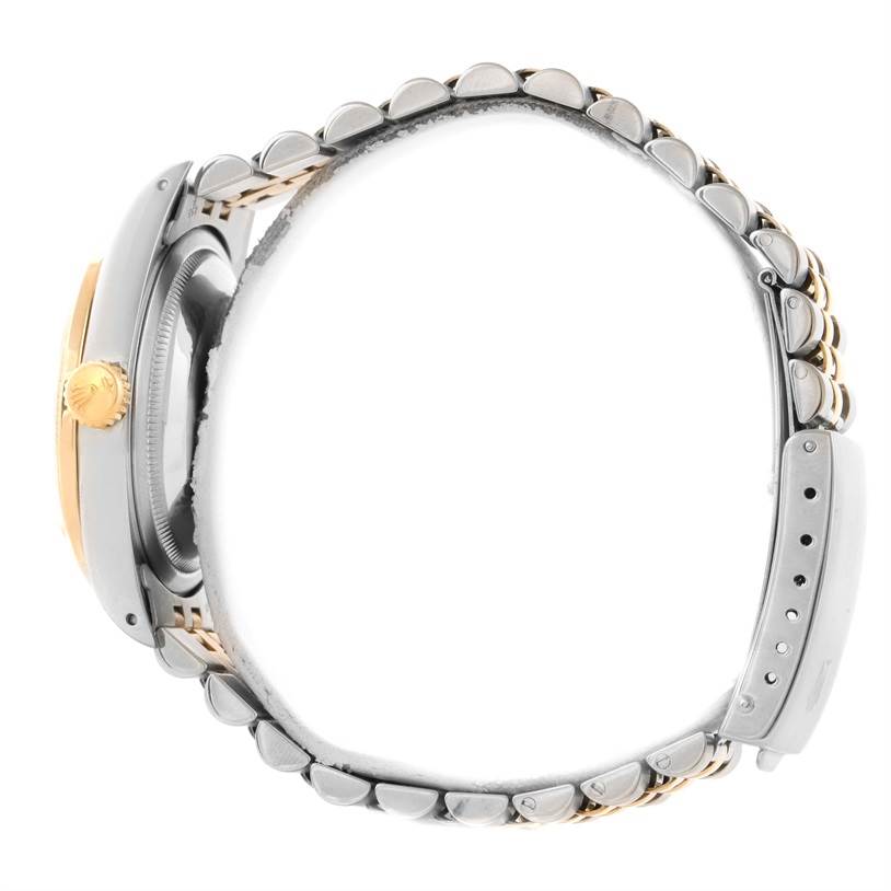 The Rolex Datejust 16233 Men's Steel and Gold (two tone) Mother of Pearl Dial 16233 Men's Steel and Gold (two tone) Mother of Pearl Dial watch is shown from a side profile, highlighting the crown, case, and part of the bracelet.