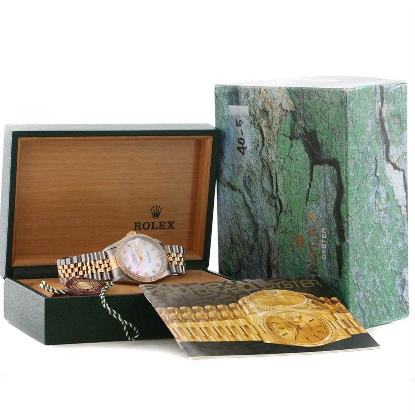 The image shows a Rolex Datejust 16233 Men's Steel and Gold (two tone) Mother of Pearl Dial 16233 Men's Steel and Gold (two tone) Mother of Pearl Dial watch in an open green box with a booklet and original packaging beside it.