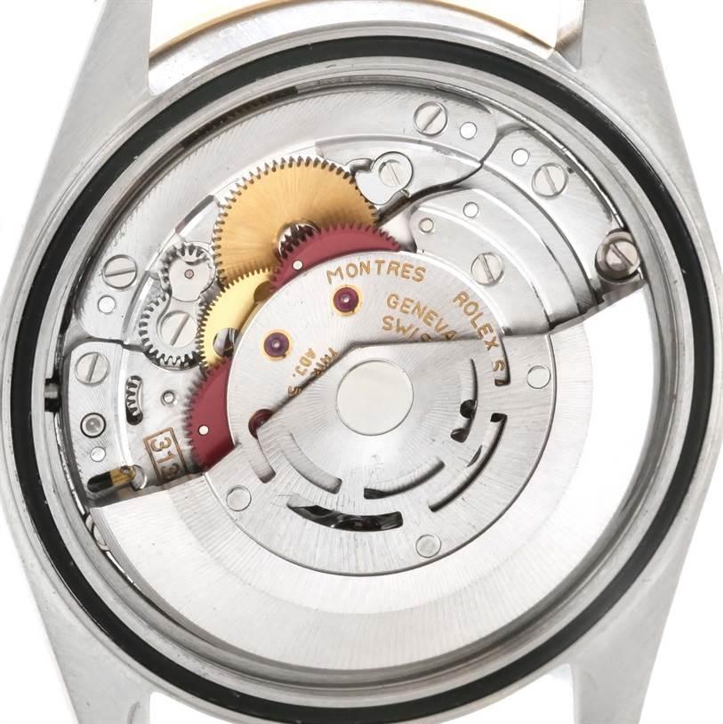 This image shows the internal mechanism of a Rolex Datejust 16233 Men's Steel and Gold (two tone) Mother of Pearl Dial 16233 Men's Steel and Gold (two tone) Mother of Pearl Dial watch, focusing on the intricate gears and rotor from the back.