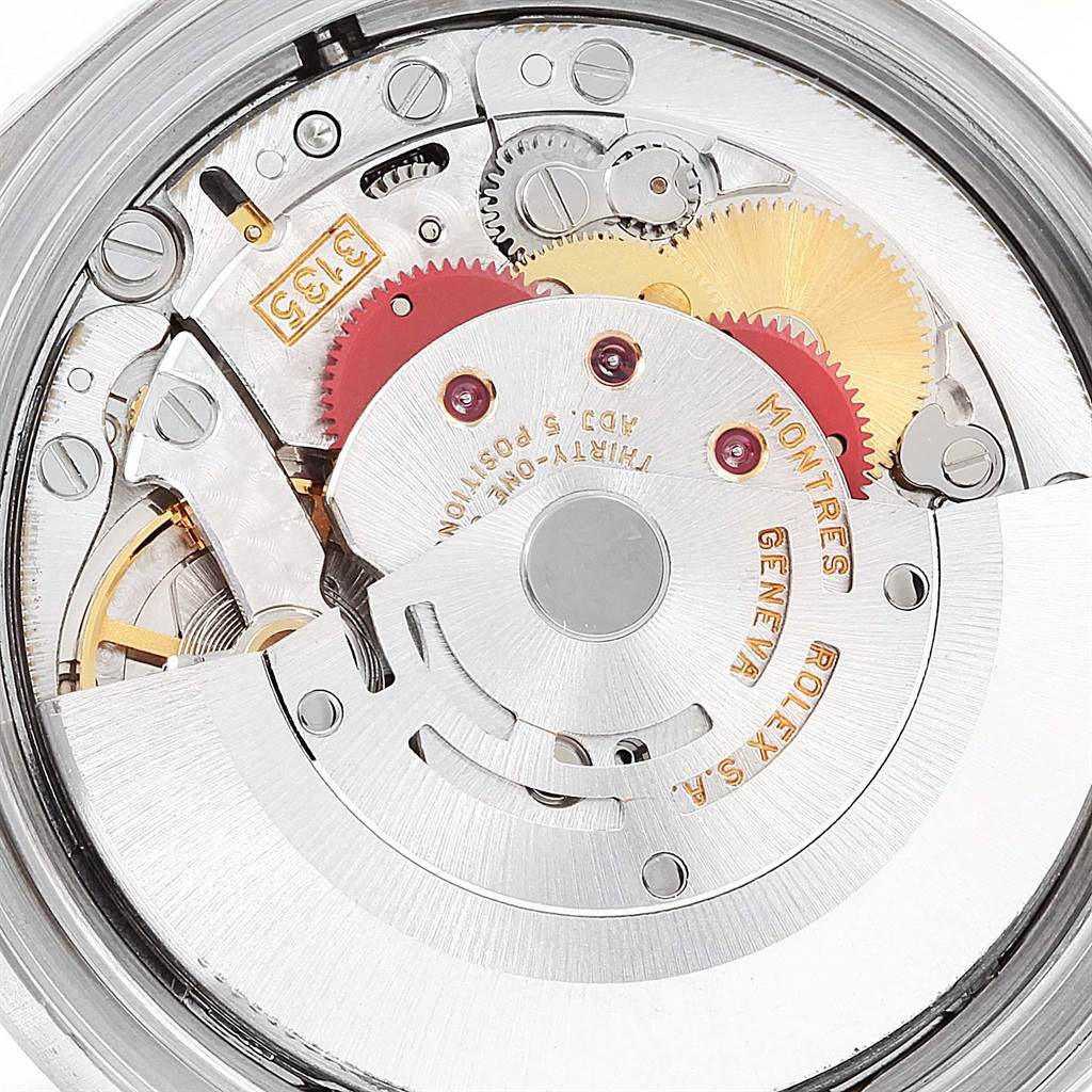 This image shows the intricate internal movement of a Rolex Datejust 16234 Men's Stainless Steel Beige Dial 16234 Men's Stainless Steel Beige Dial watch, including gears and components from an overhead view.