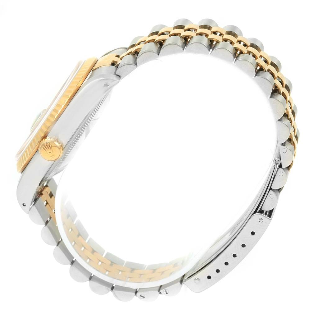 The image shows a side view of a Rolex Datejust 16233 Men's Steel and Gold (two tone) Blue Dial 16233 Men's Steel and Gold (two tone) Blue Dial watch, highlighting its two-tone bracelet and crown.