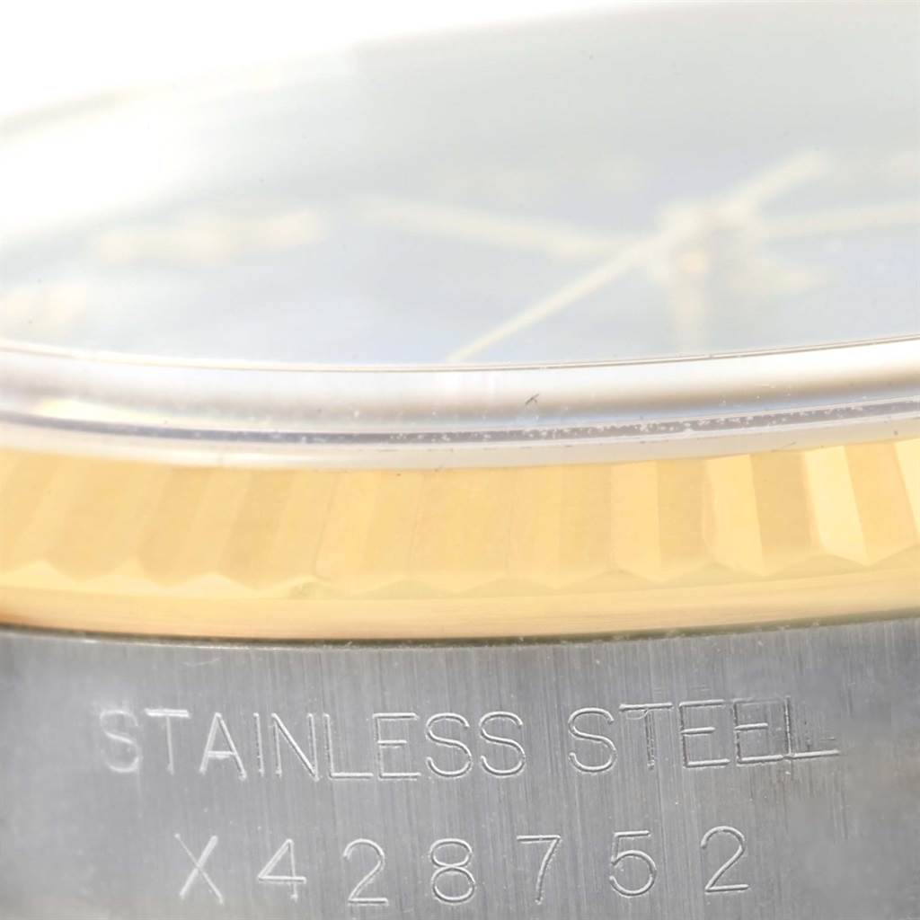 The image shows a close-up of the case side, bezel, and serial number of a Rolex Datejust 16233 Men's Steel and Gold (two tone) Blue Dial 16233 Men's Steel and Gold (two tone) Blue Dial watch.