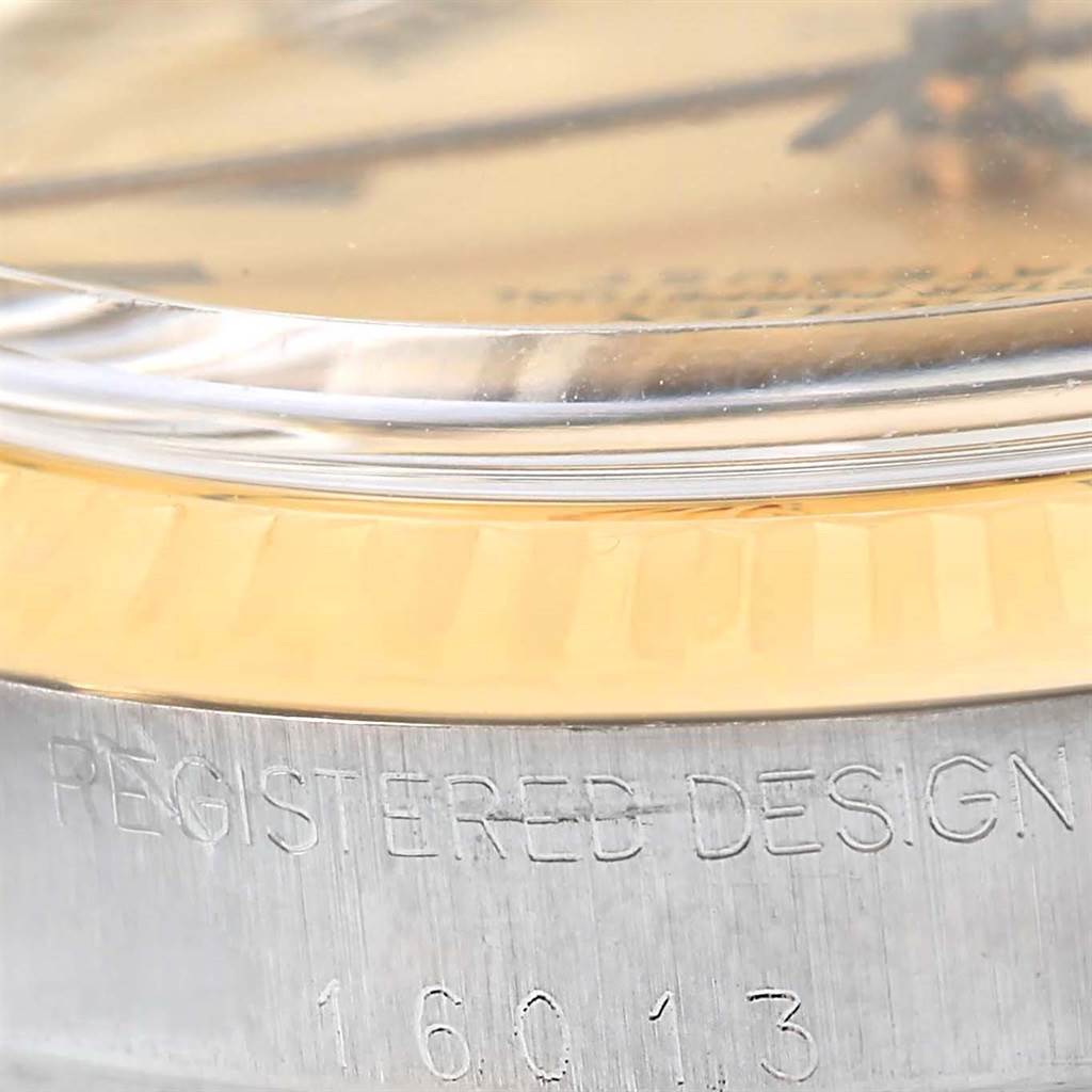 This close-up angle of the Rolex Datejust 16013 Men's Stainless Steel Champagne Dial 16013 Men's Stainless Steel Champagne Dial watch shows the edge of the crystal, bezel, and part of the casing.