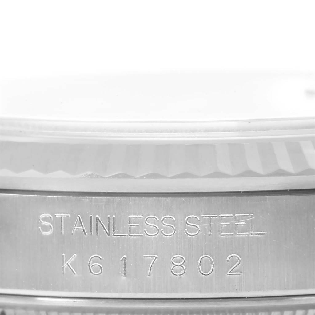 This image shows a close-up of the side of a stainless steel Rolex Datejust 16234 Men's Stainless Steel Blue Dial 16234 Men's Stainless Steel Blue Dial watch case with engraved serial number K617802.