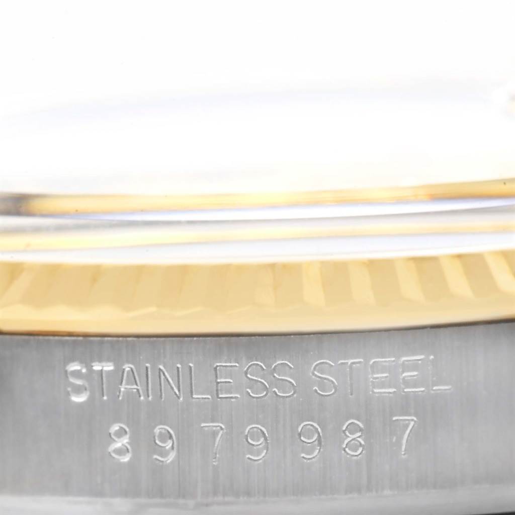 This image shows a close-up of the Rolex Datejust 16013 Men's Stainless Steel Champagne Dial 16013 Men's Stainless Steel Champagne Dial watch's stainless steel case with serial number engraving.