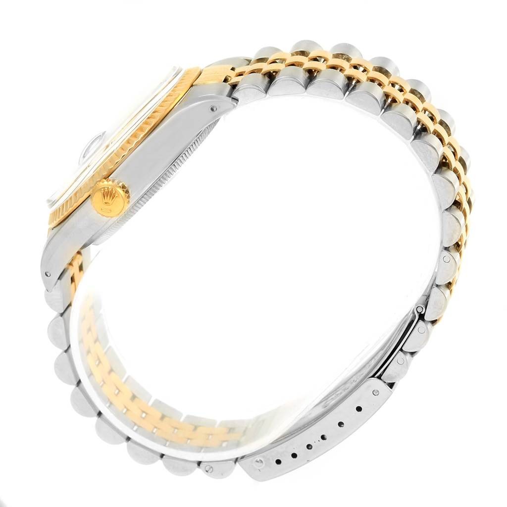 The image shows a side angle of a Rolex Datejust 16013 Men's Stainless Steel Champagne Dial 16013 Men's Stainless Steel Champagne Dial watch, highlighting the gold crown, bezel, and two-tone bracelet.