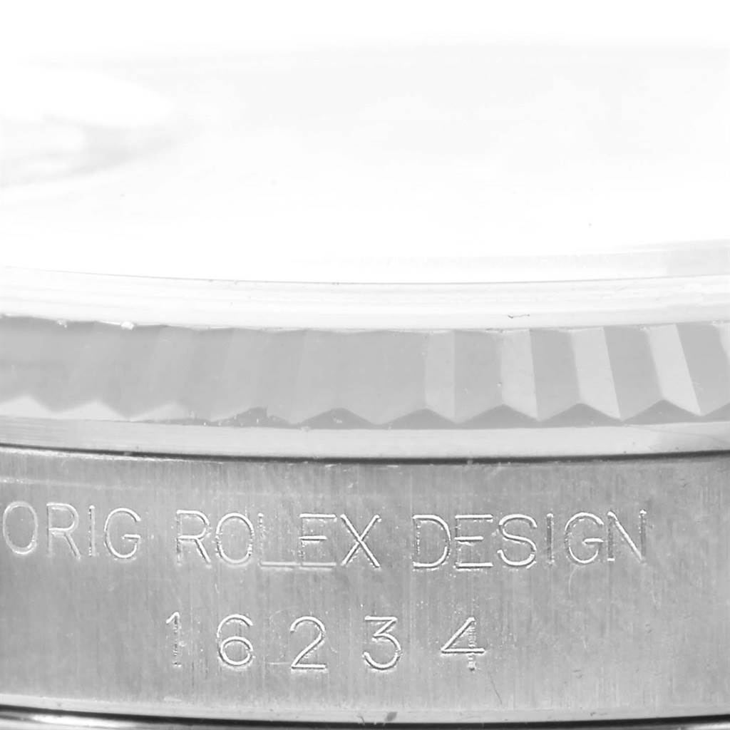This close-up image of the Rolex Datejust 16234 Stainless Steel Silver Dial 16234 Stainless Steel Silver Dial watch shows the side view of its bezel and engraved serial number.