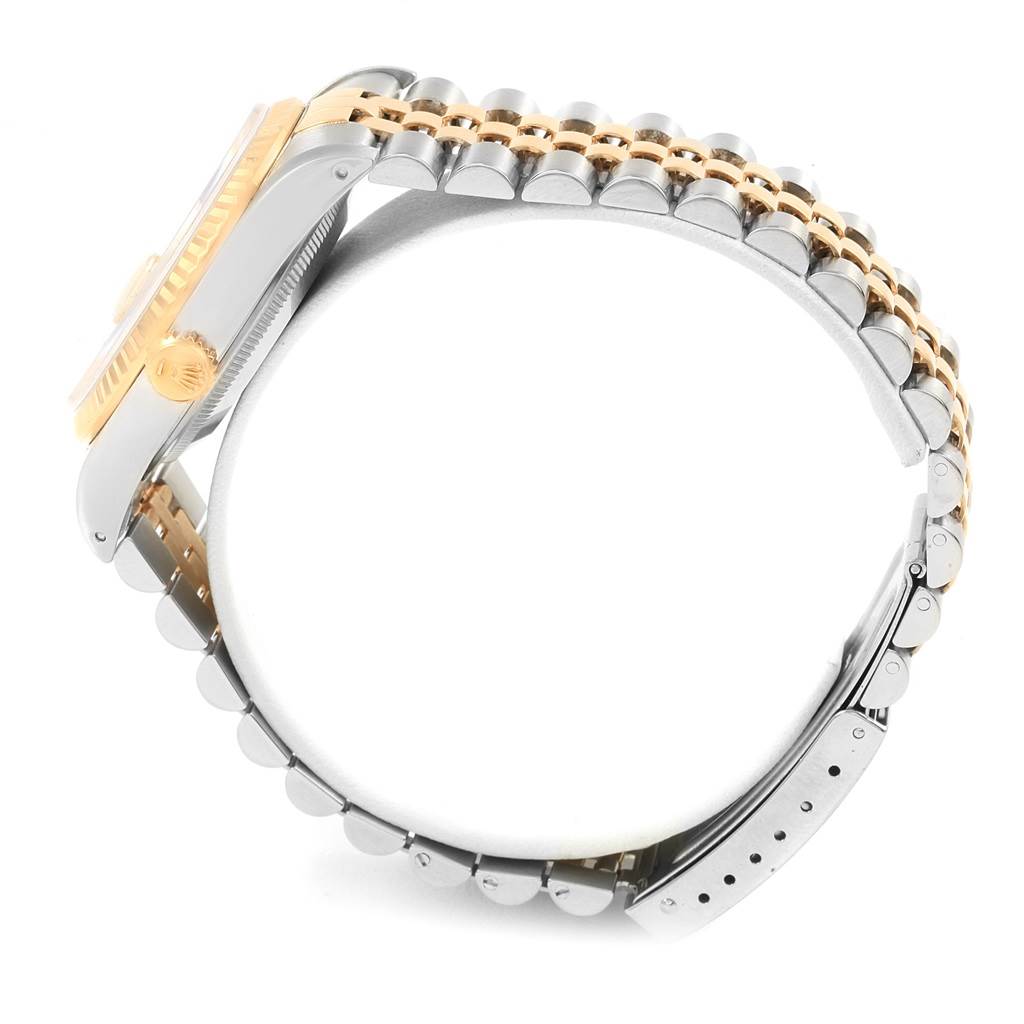 The image shows a side view of the Rolex Datejust 16233 Men's Steel and Gold (two tone) Champagne Dial 16233 Men's Steel and Gold (two tone) Champagne Dial watch, highlighting its two-tone bracelet, case, and crown.