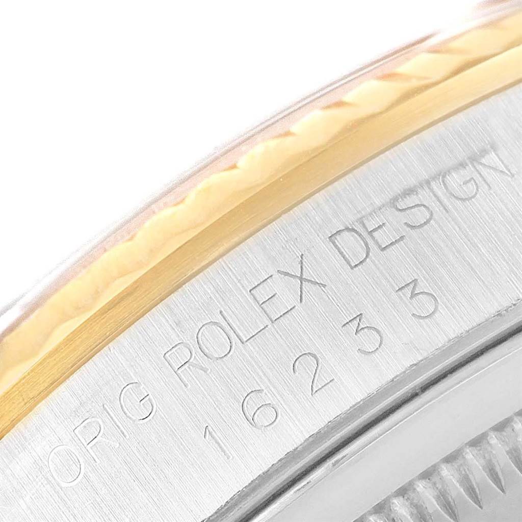 This image shows a close-up of the engraved bezel and case of a Rolex Datejust 16233 Men's Steel and Gold (two tone) Champagne Dial 16233 Men's Steel and Gold (two tone) Champagne Dial model watch, with the model number 16233 visible.