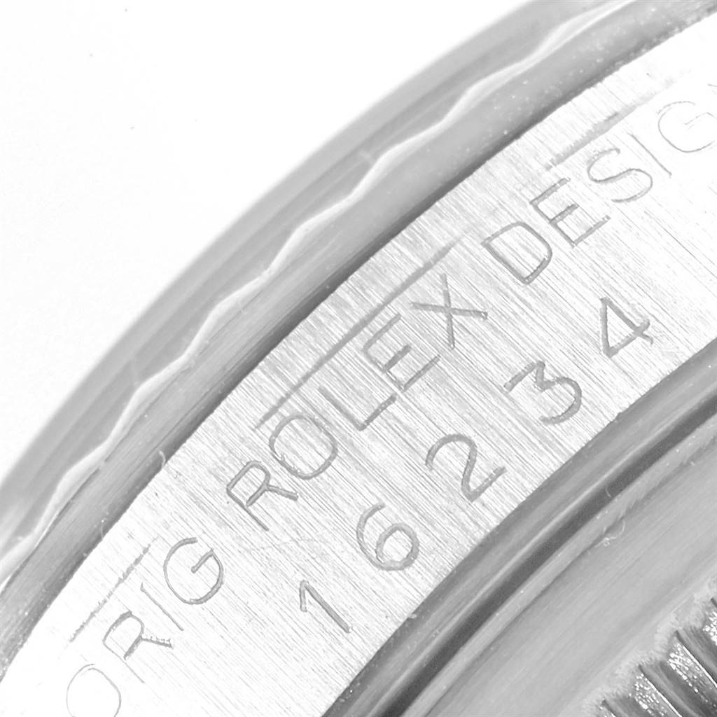 This image shows a close-up angle of the bezel and the engraved serial number on a Rolex Datejust 16234 Men's Stainless Steel Silver Dial 16234 Men's Stainless Steel Silver Dial watch.